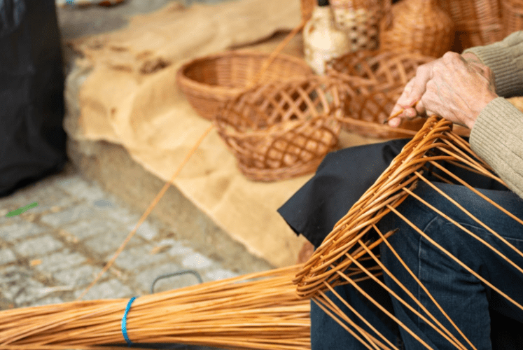 person weaving rattan furniture